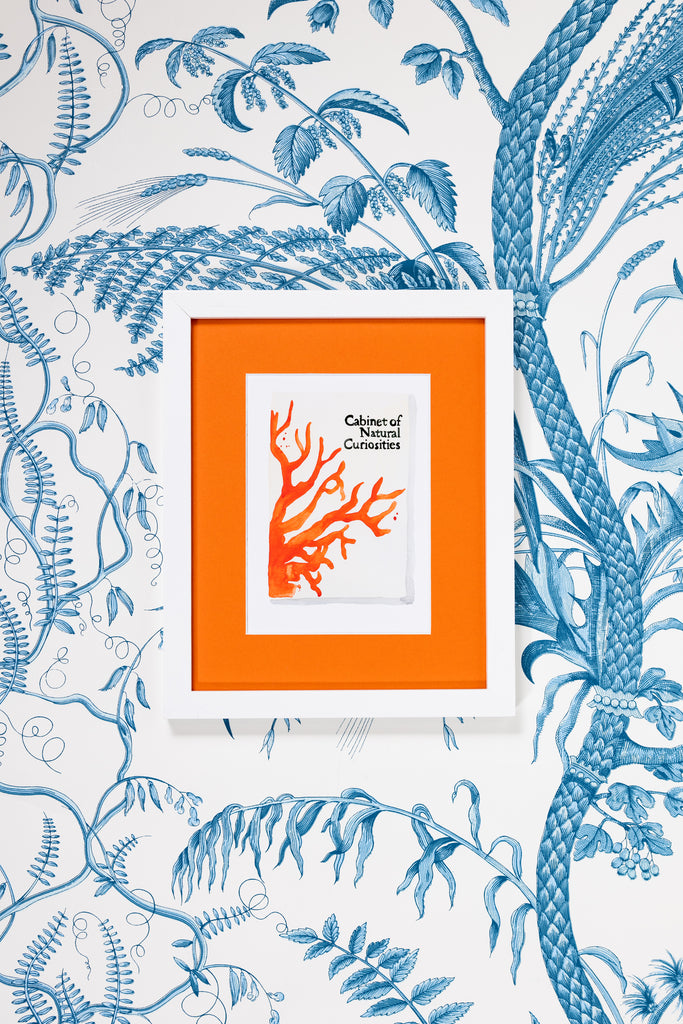 Cabinet of Natural Curiosities Book - Furbish Studio, A matchbook watercolor print with tree branches painted in orange and a dirty white background in a 5x7 white frame with a wallpaper background
