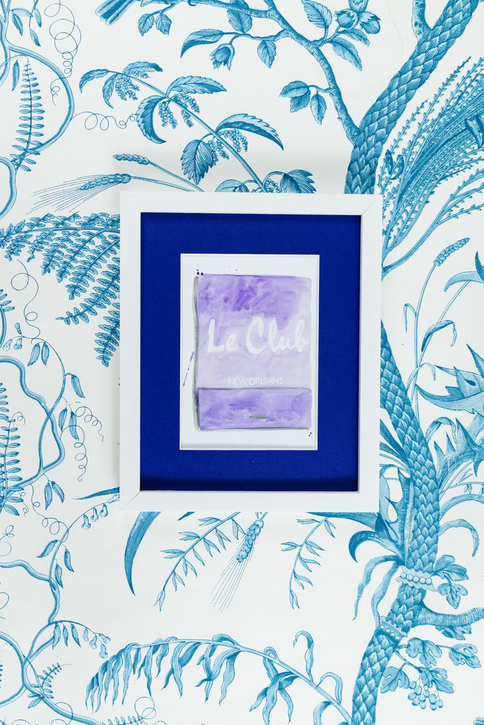 Le Club Matchbook - Furbish Studio, Le Club New Orleans matchbook watercolor print with a lavender background paint and the "Le Club New Orleans" is painted in white in the middle in a 5x7 white frame with a wallpaper background