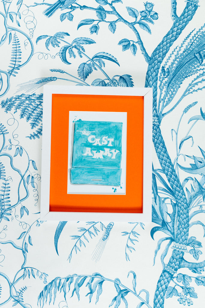 Cast Away Matchbook - Furbish Studio, A matchbook watercolor print with turquoise paint as its background shade and "The Cast Away" painted in white in a 5x7 white frame with a wallpaper background