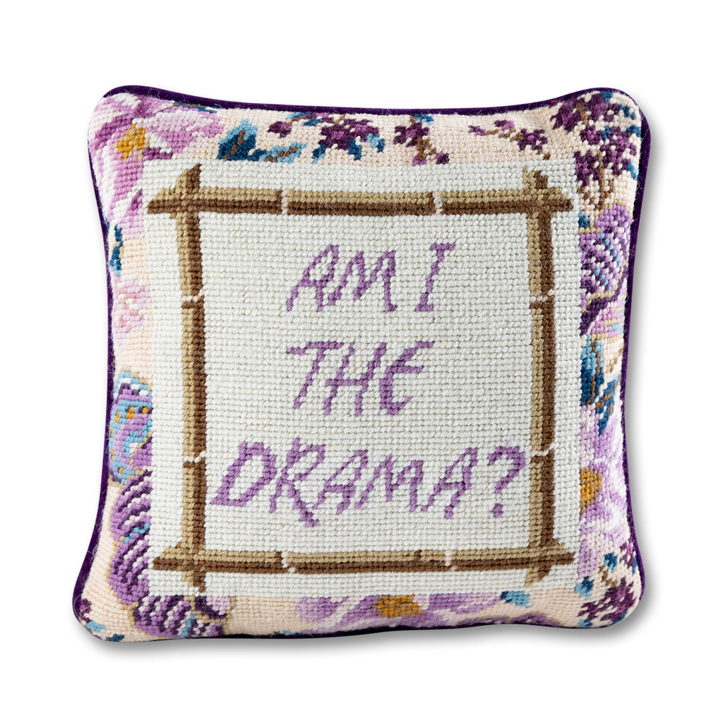 front view of the luxe purple velvet chic hand needlepoint pillow with "Am I the Drama" saying written in purple enclosed in a square shaped bamboo design surrounded by purplish patterns 