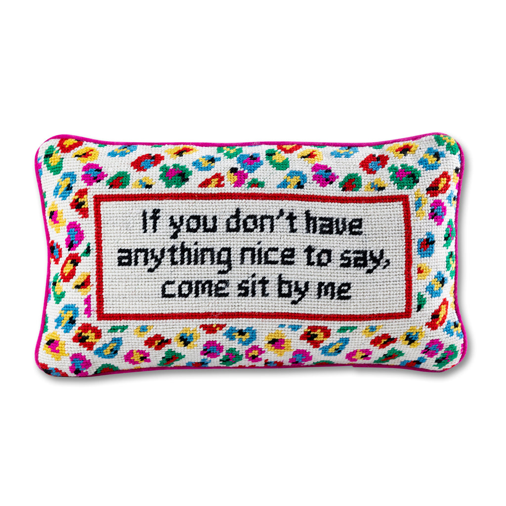 front view of the luxe pink velvet chic hand needlepoint pillow with "If you don't have anything nice to say, come sit by me" saying written in black surrounded by colorful patterns with a white background
