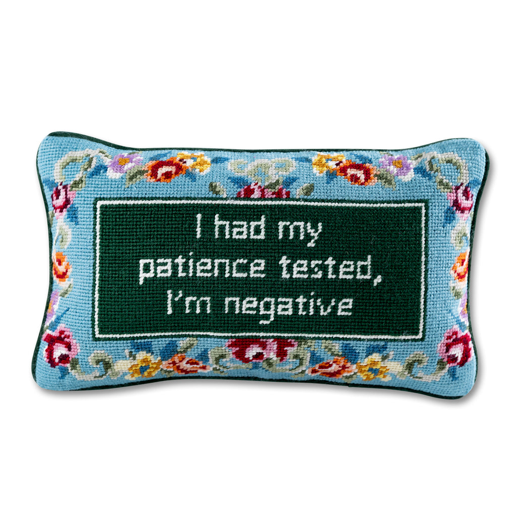 front view of the luxe dark green velvet chic hand needlepoint pillow with "I had my patience tested, I'm negative" saying written in white enclosed in a square shaped dark green design surrounded by colorful flowery patterns