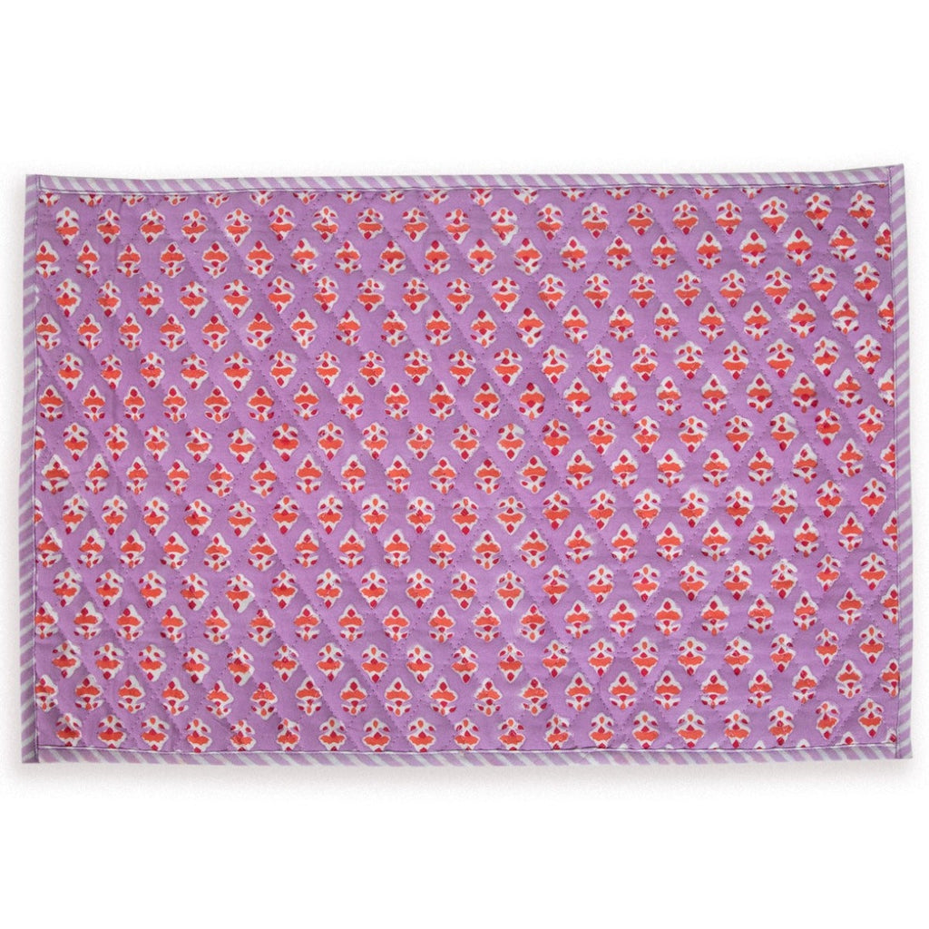 an in-depth look of a lilac block print handmade placemat with orange flowers and straight edge stripes