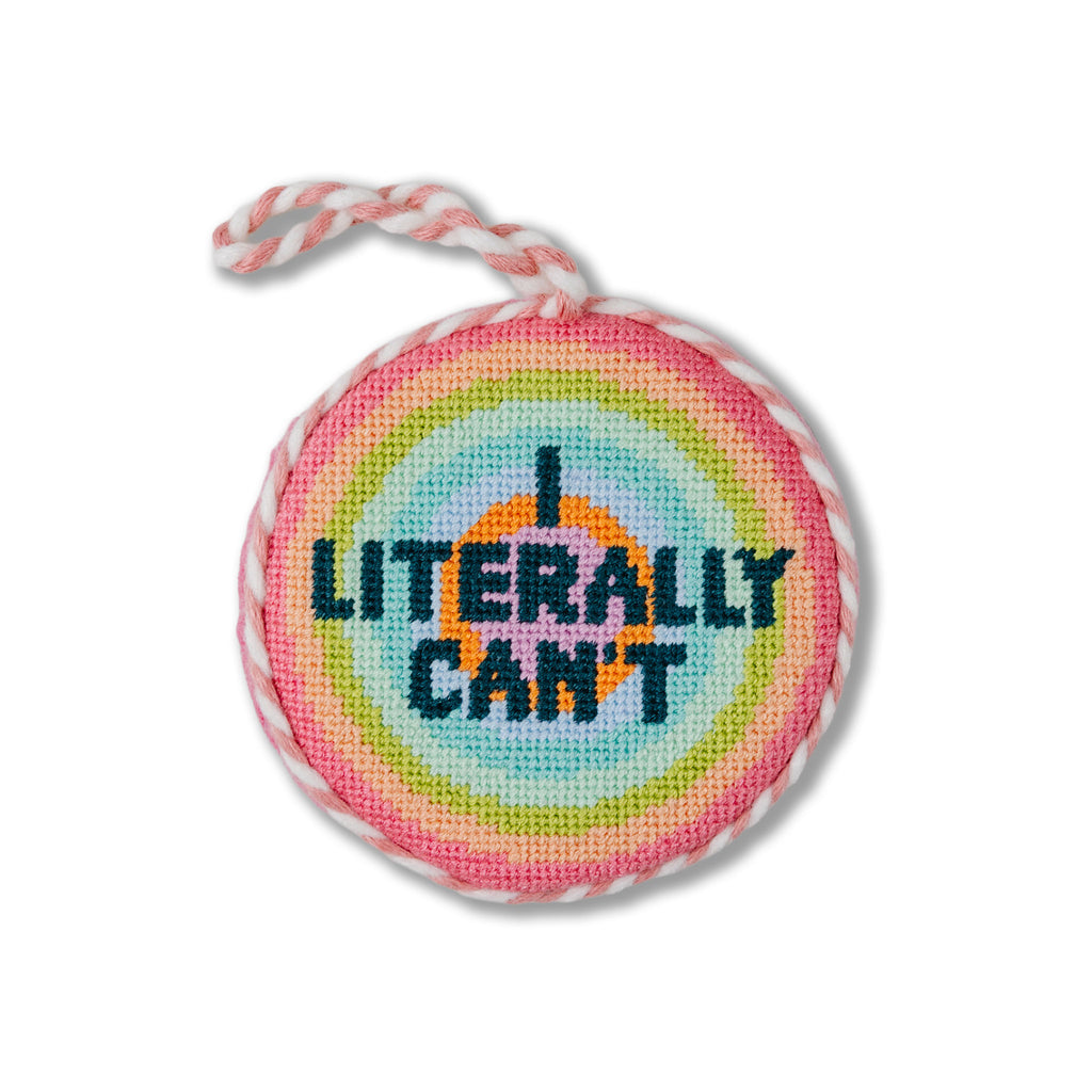 Round needlepoint ornament with 'I Literally Can't' text on a white background