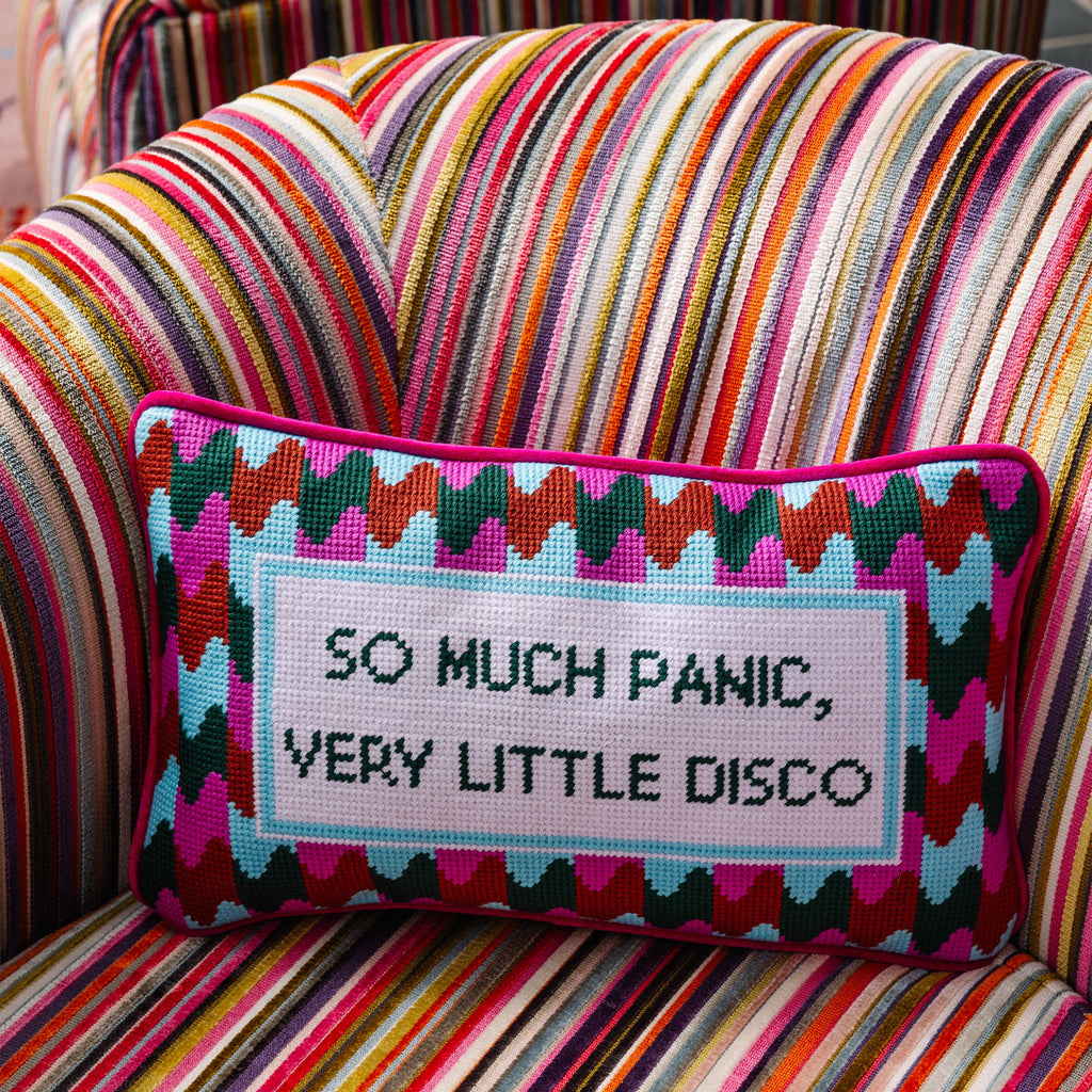 Decorative pillow with text on a multicolored striped chair
