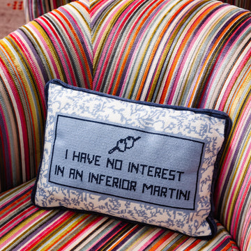 Decorative pillow with text on a striped armchair