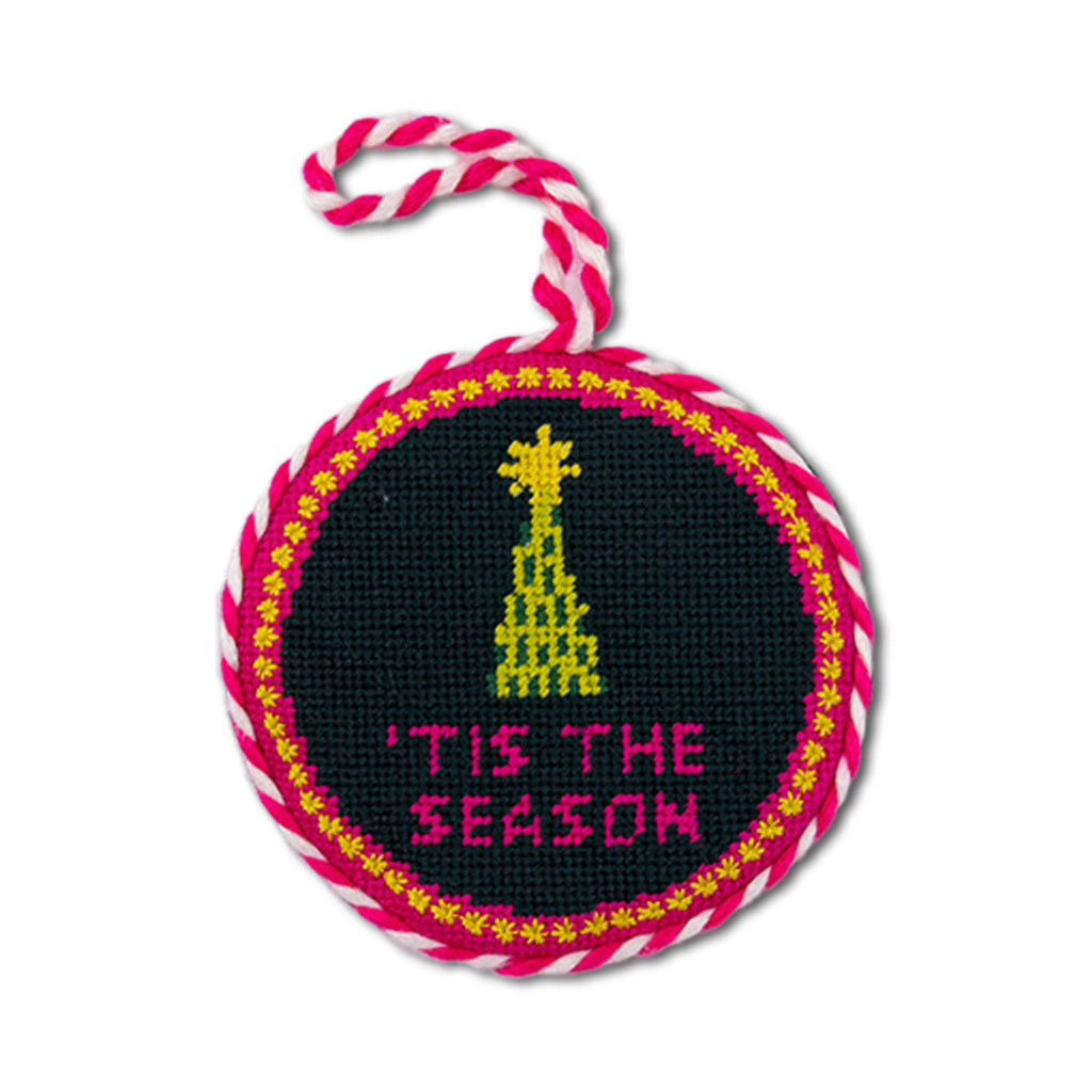 Decorative ornament with 'Tis the Season text and Christmas tree design on a black background.