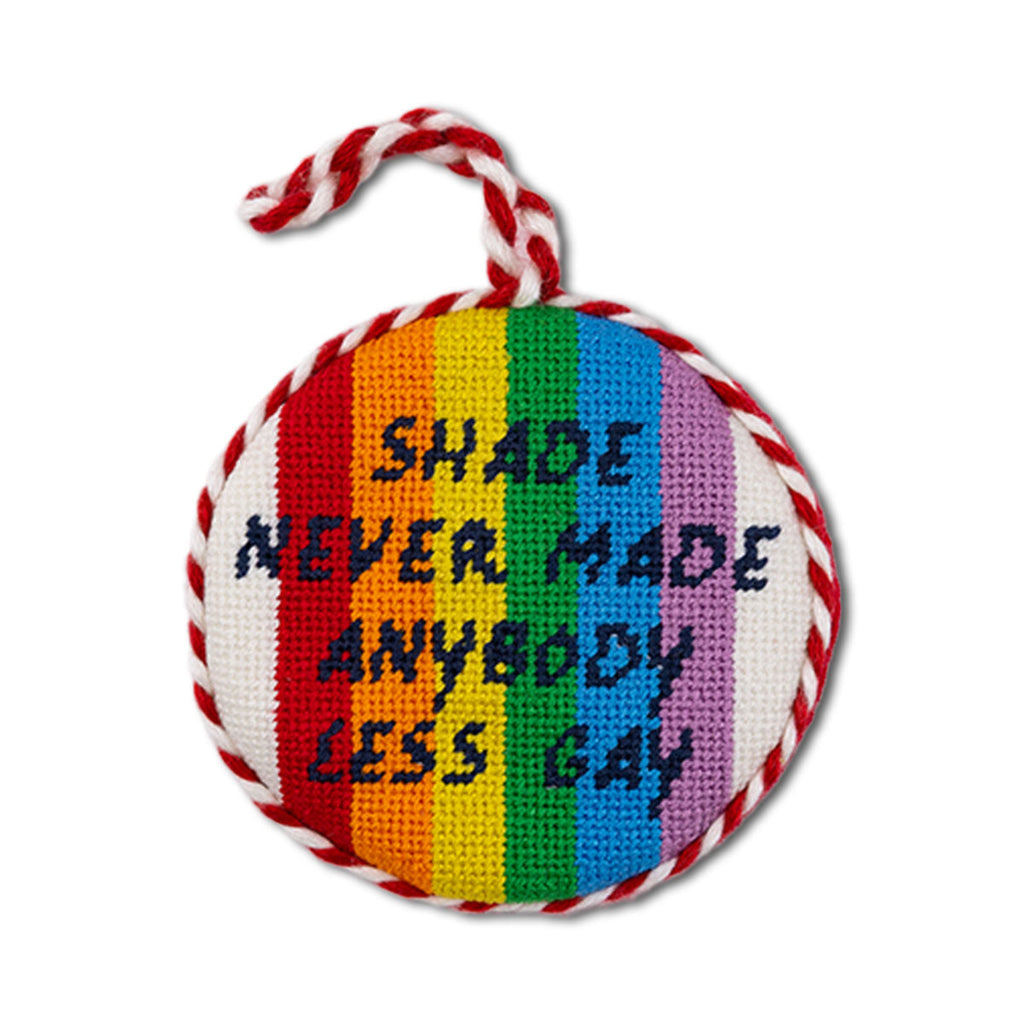 Round rainbow-colored knitted item with text on a white background