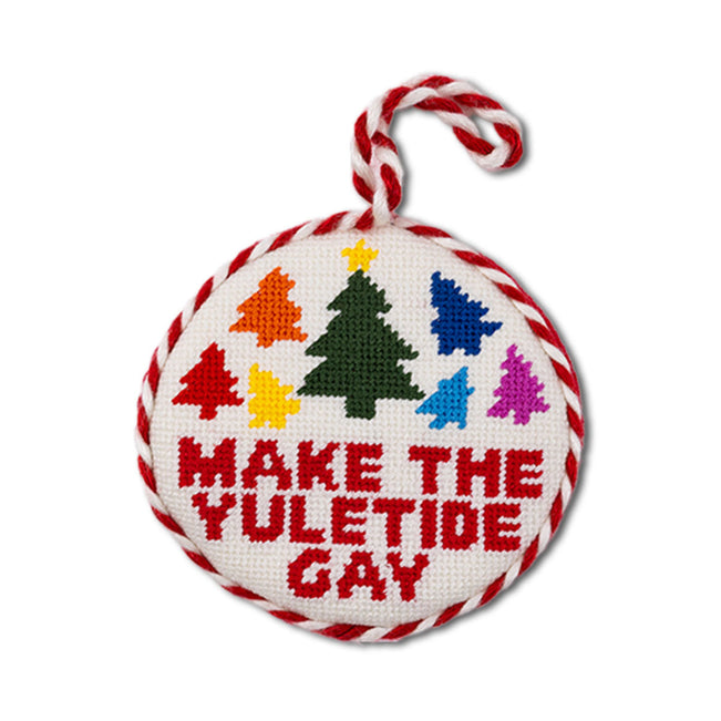 Decorative ornament with colorful trees and text 'Make the Yuletide Gay' on a white background