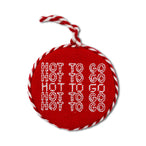Red round ornament with white text and red and white string on a white background