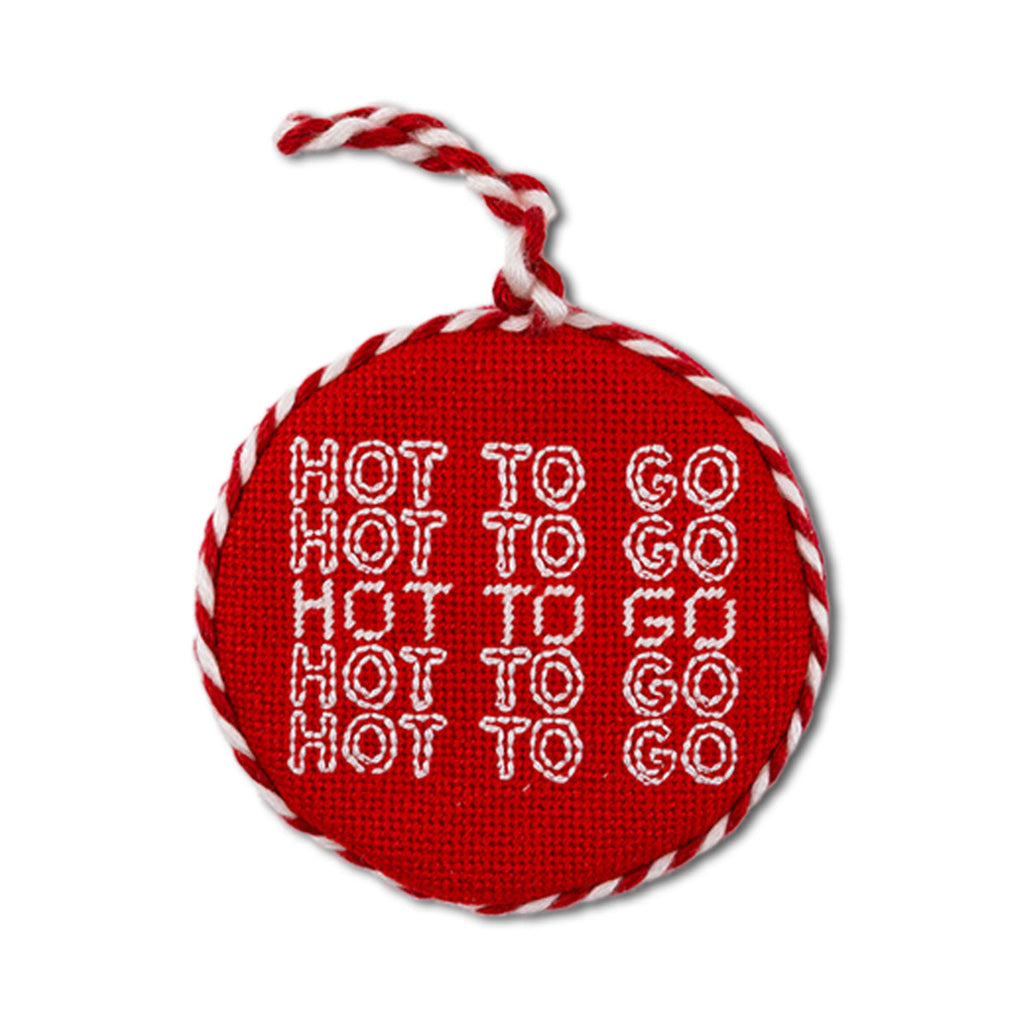 Red round ornament with white text and red and white string on a white background