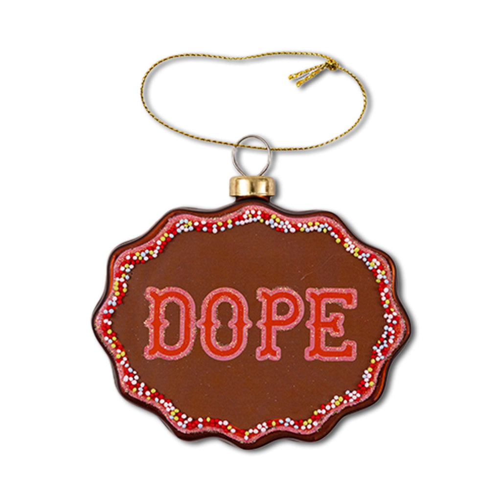 A brown scallop-shaped Christmas ornament with the text 'DOPE' in red, decorative patterns around the border, and a gold hanging string.
