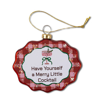 A scalloped, round Christmas ornament with a red and white checkered border and a green decorative element in the center, with the text 'Have Yourself a Merry Little Cocktail' displayed.