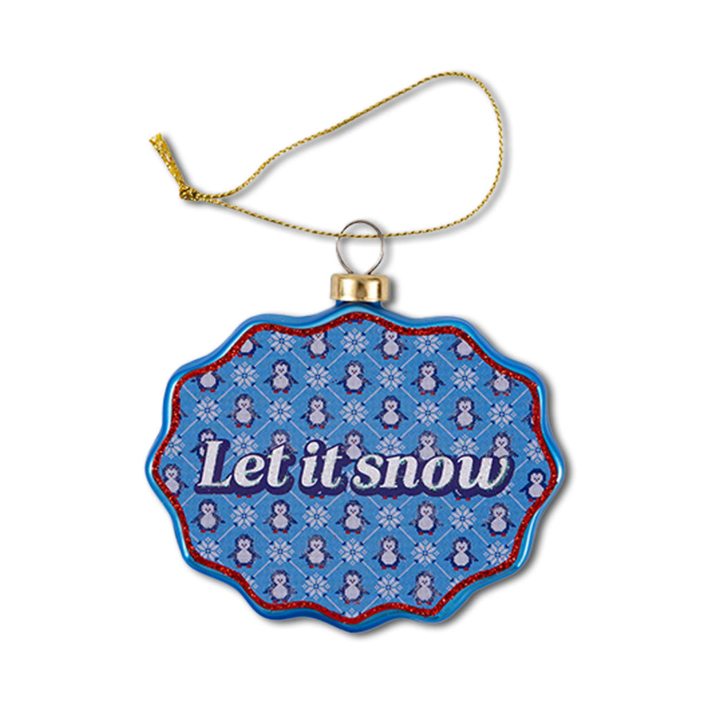 A scalloped glass ornament with a blue and white pattern, featuring the text 'Let it snow' at the center, and a decorative hanging loop.