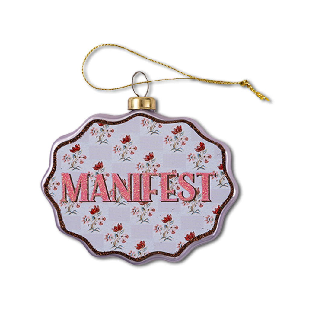 Decorative ornament with 'MANIFEST' text on a floral patterned background