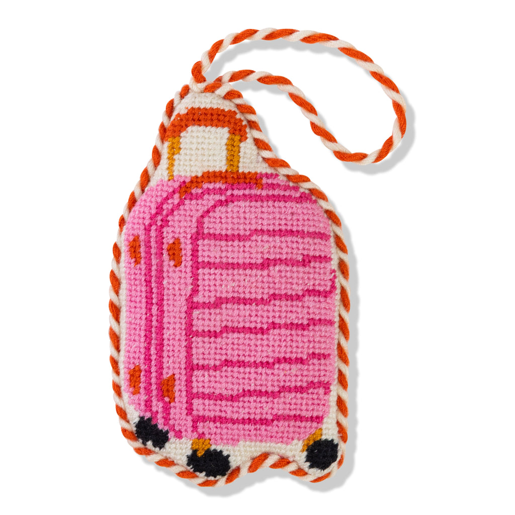 Pink suitcase-shaped keychain with orange accents on a white background