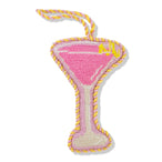 Pink martini glass-shaped toy with yellow accents on a white background
