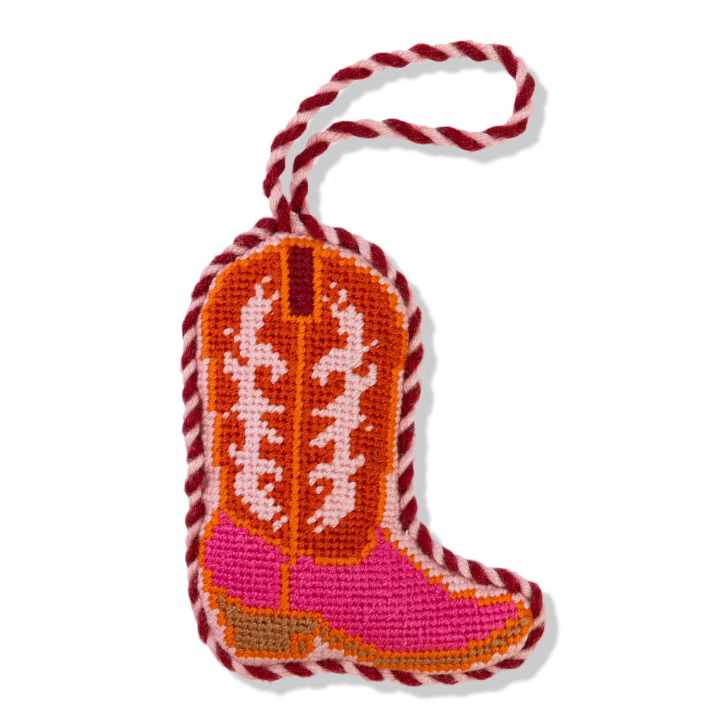 Decorative cowboy boot ornament with pink and orange design on a white background