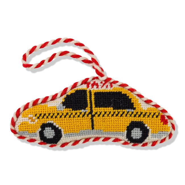 Yellow taxi-shaped toy with red and white rope on a white background