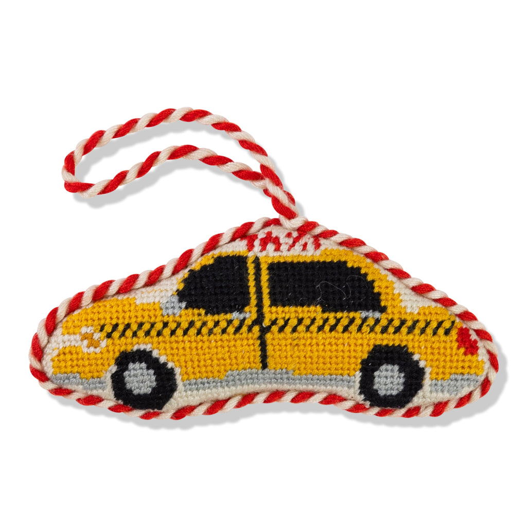 Yellow taxi-shaped toy with red and white rope on a white background