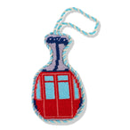 Decorative keychain with a red and blue checkered design on a white background