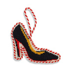 Decorative high-heeled shoe ornament with red and white rope on a white background