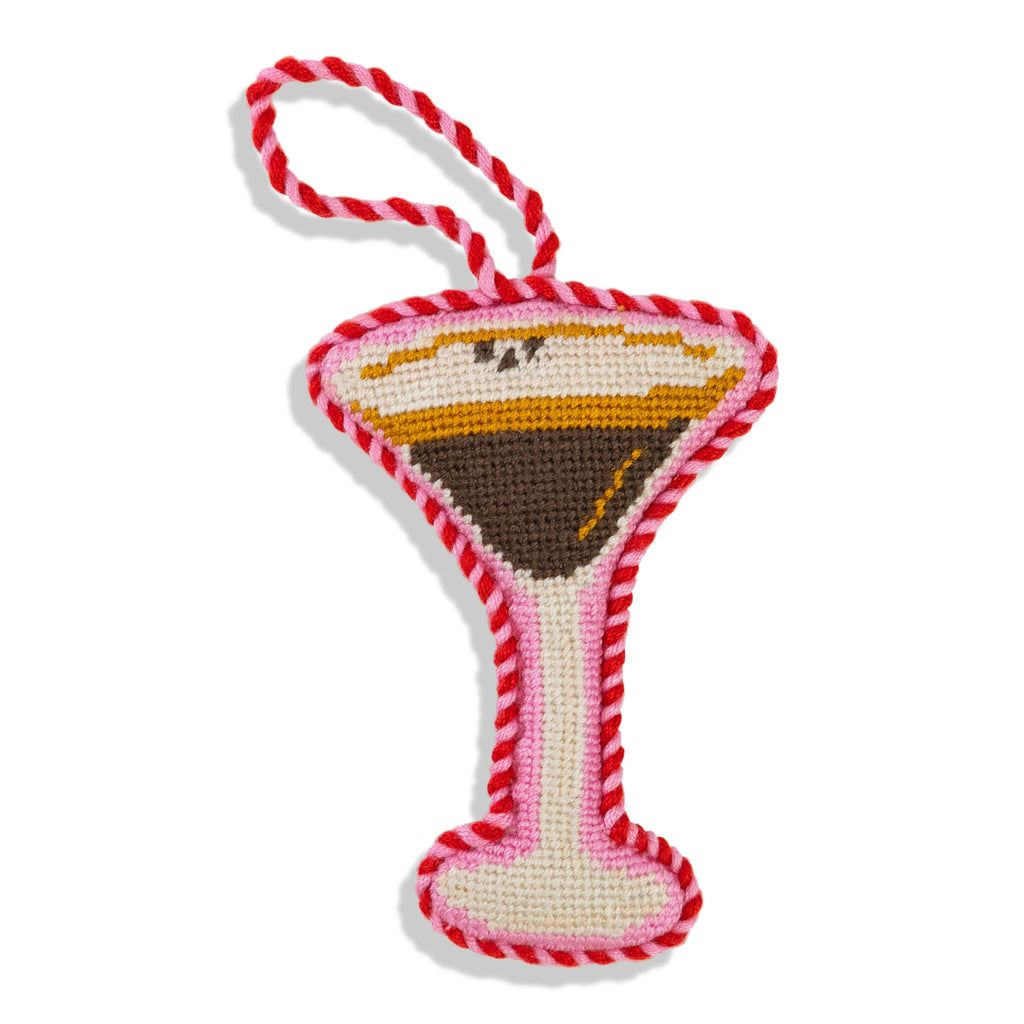 Dog toy shaped like a martini glass with red and white striped handle on a white background