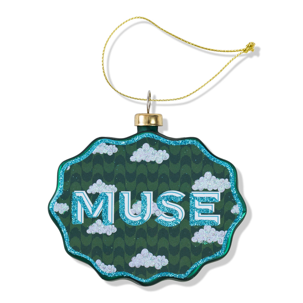 Decorative ornament with 'MUSE' text on a green background with cloud patterns.
