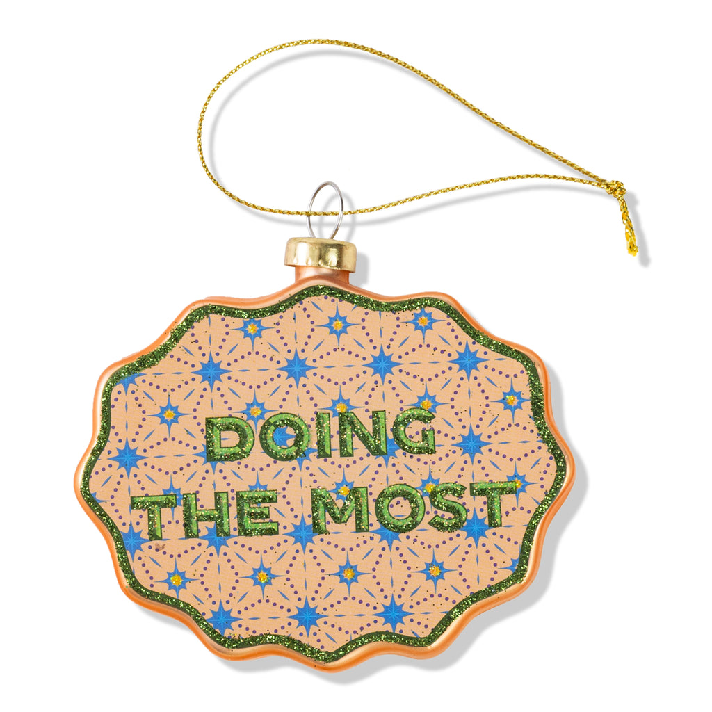 Decorative ornament with 'DOING THE MOST' text on a white background