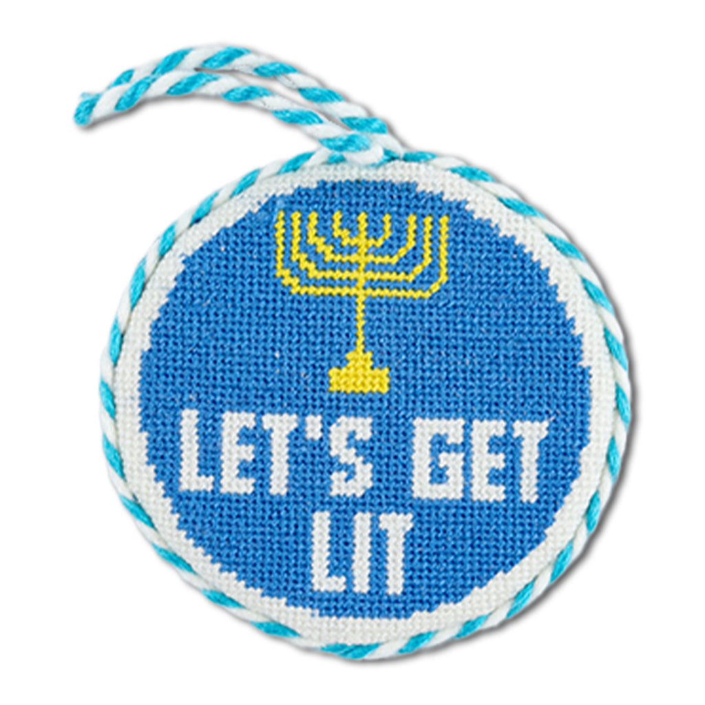 Circular blue needlepoint ornament with Menorah design and 'Let's Get Lit' text on white background