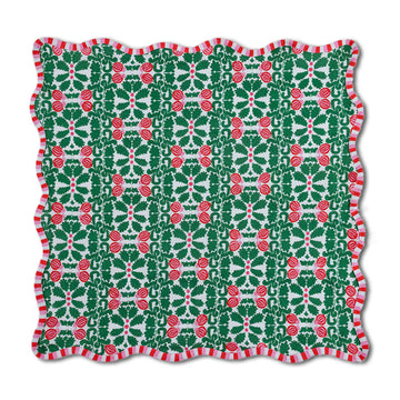 Christmas-themed fabric with red holly berries and green leaves on a white background