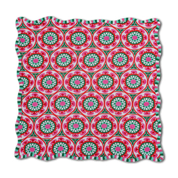 Decorative pillow with a pink and green circular pattern on a white background