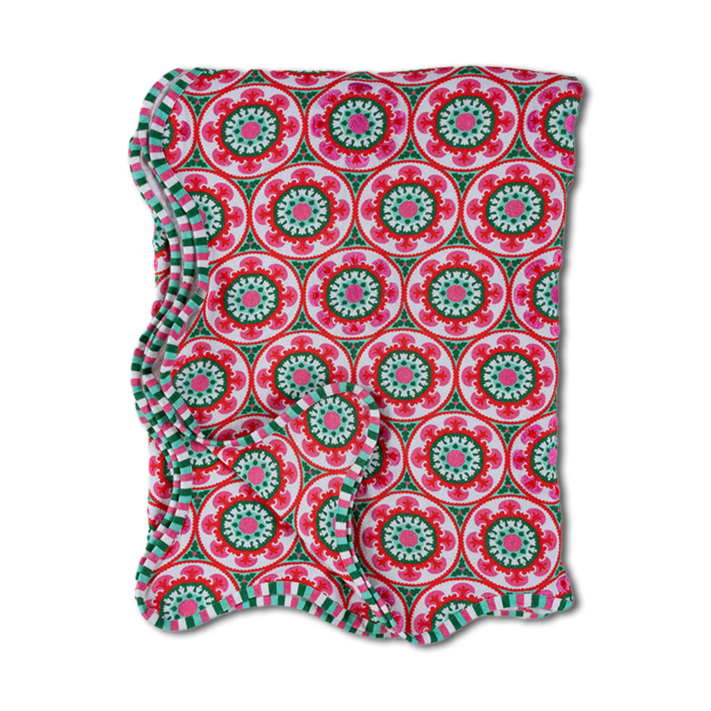 Folded fabric with a red and green circular pattern on a white background