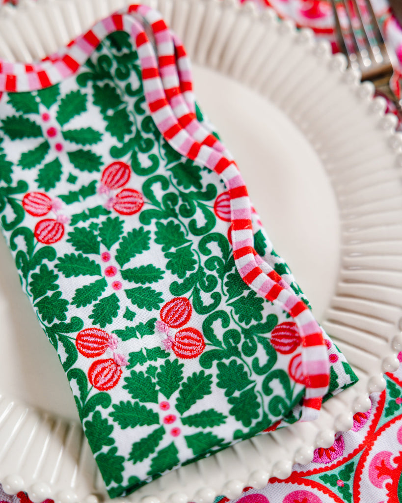 Colorful patterned napkins on a white plate with a fork