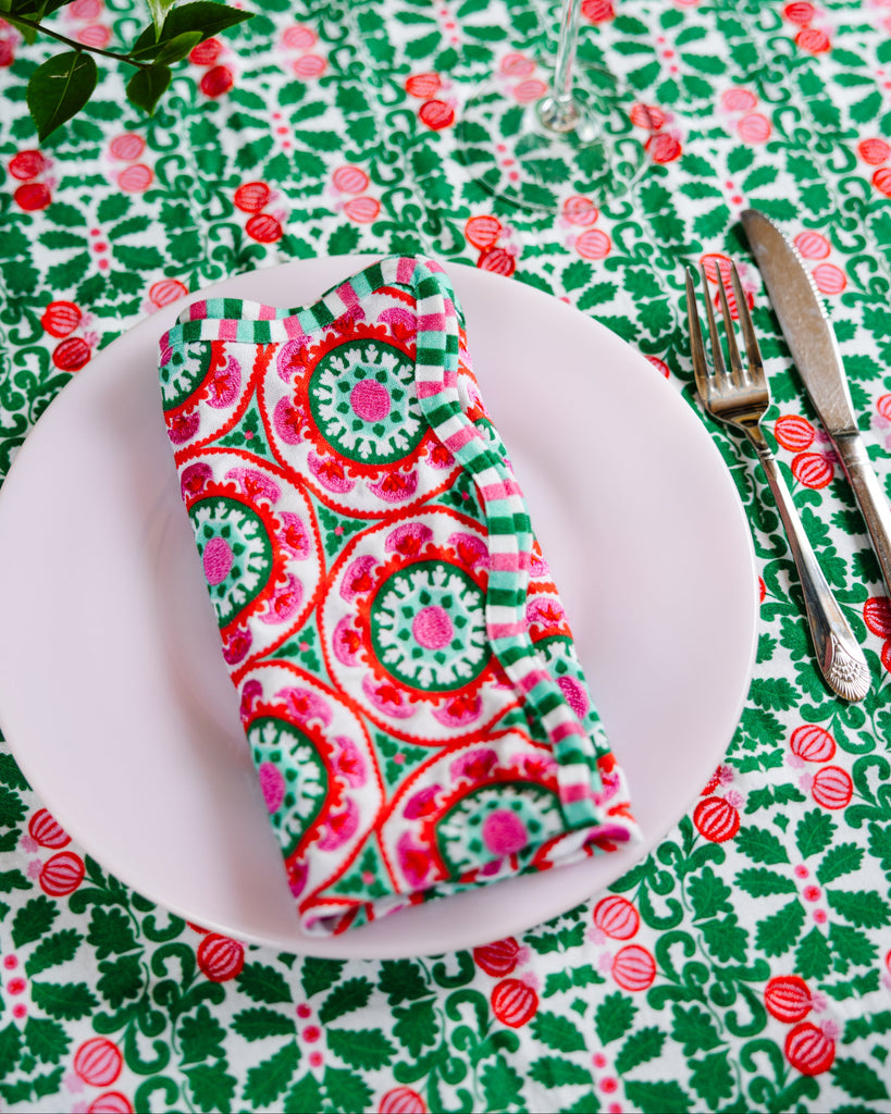 Colorful napkin on a plate with a patterned tablecloth