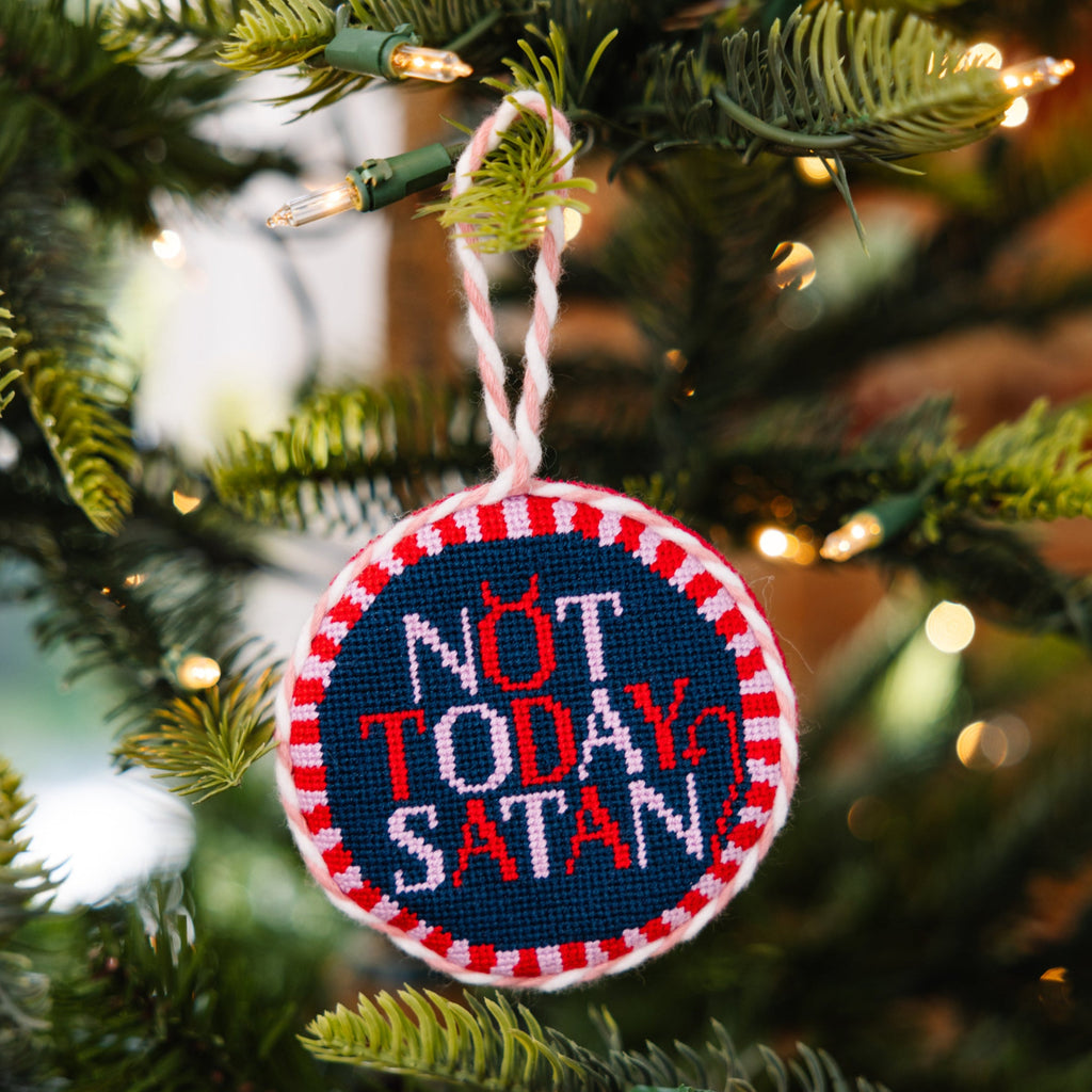 Decorative ornament with 'Not Today Satan' text on a Christmas tree.
