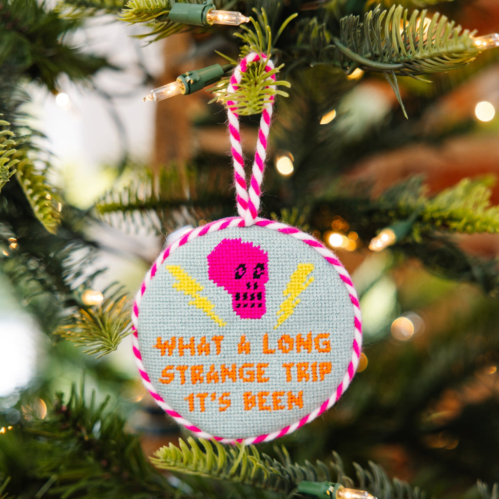 Decorative ornament with skull design and text on a Christmas tree