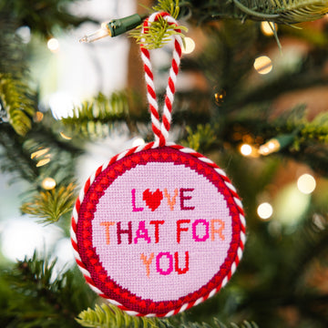 Decorative Christmas ornament with 'Love That For You' text on a tree.