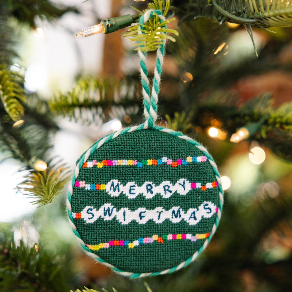Decorative Christmas ornament with 'Merry Swiftmas' text on a tree.