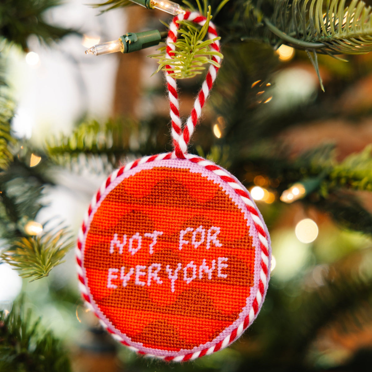 Decorative ornament with 'Not for Everyone' text on a Christmas tree.
