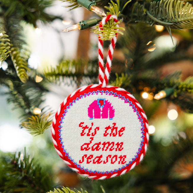 Decorative Christmas ornament with text on a Christmas tree