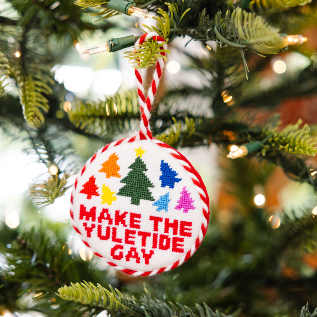 Christmas ornament with colorful text and symbols on a tree