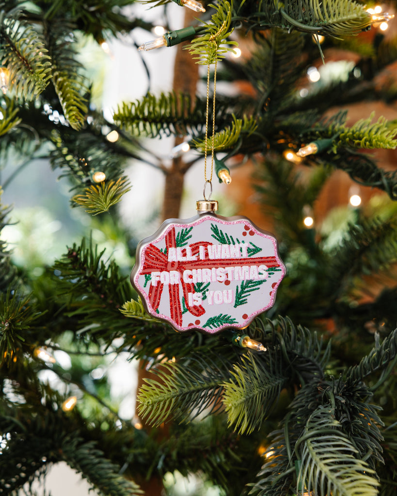 Decorative Christmas ornament with red and green design on a Christmas tree.