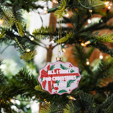 Decorative Christmas ornament with red and green design on a Christmas tree.
