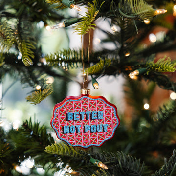 Decorative ornament with 'Better Not Pour' text on a Christmas tree.