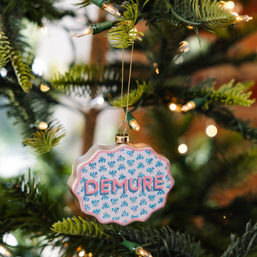Decorative ornament with 'DEMU' text on a Christmas tree
