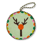 Round needlepoint ornament with deer design on a light green background