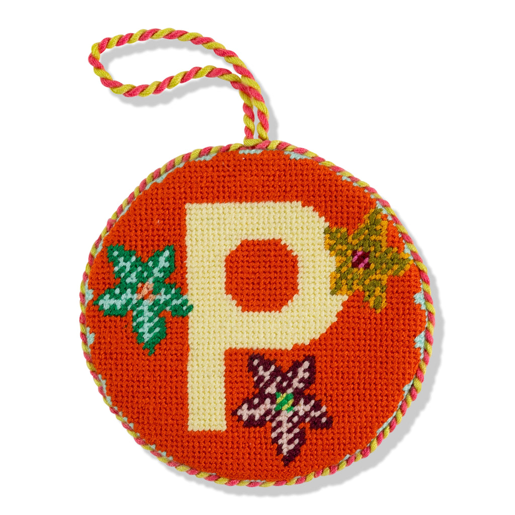 Decorative ornament with letter 'P' on an orange background