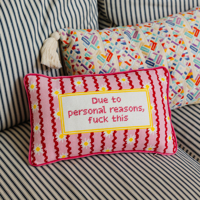 Decorative pillow with text on a striped sofa