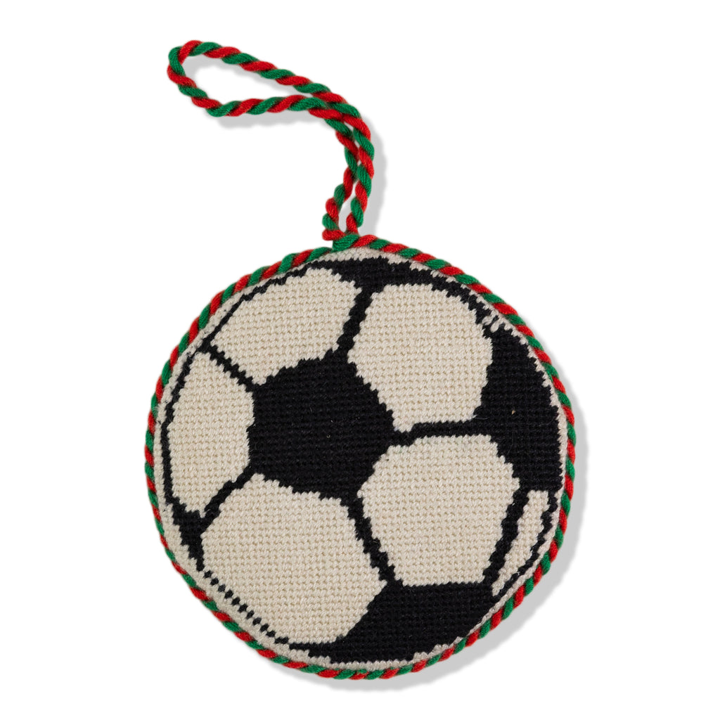 Soccer ball-shaped knitted toy with a rope on a white background